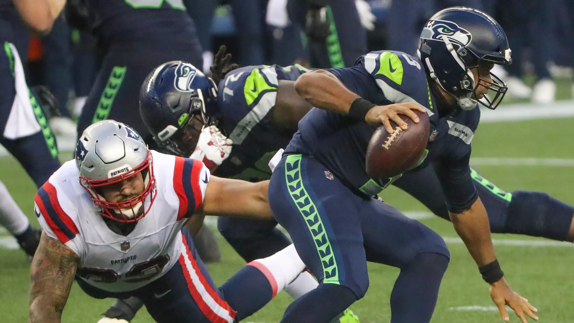<p>Frustrating time having to try to defend an alien at the quarterback position. Has to be. Not only is Russell Wilson one of the best deep-ball throwers in the league, but he's so quick in tight spaces that it's difficult to hem him in and keep him in the pocket -- all he needs is a small crease -- and he's short enough that when he's juking behind the line, he crouches down behind his blockers and can be hard to find. Seemed to happen time and again Sunday night.</p>
<p>Wilson ended up with five scrambles for 39 yards -- 7.8 yards per attempt -- and four of those went for first downs. That's partly on the big bodies up front for not being able to control their blocks and crush Wilson's pocket around him during lengthy dropbacks. </p>
<p>Even though players like Lawrence Guy (five pressures, two quarterback hits) and Deatrich Wise (two pressures, one hit) had multiple reps where they got into the Seahawks backfield, some of those rushes left openings for Wilson to exploit with his legs. Every runner on Seattle's roster had at least 4.2 yards per carry, and as a group they racked up over 5.0 yards per attempt.</p>