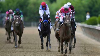 May 15, 2021; Baltimore, Maryland, USA; Flavien Prat aboard Rombauer breaks away from the pack to winthe 146th running of the Preakness Stakes at Pimlico Race Course. Mandatory Credit: Tommy Gilligan-USA TODAY Sports
