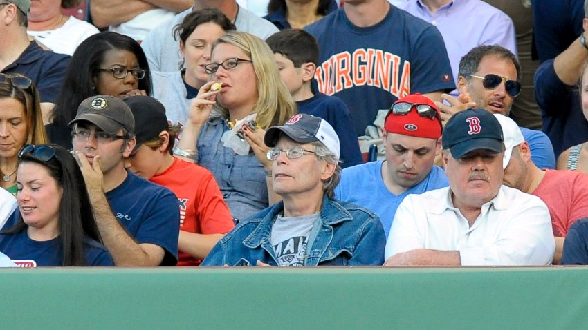 Jun 16, 2014; Boston, MA, USA; American author Stephen King (center) takes in the game between the Boston Red Sox and Minnesota Twins at Fenway Park. Mandatory Credit: Bob DeChiara-USA TODAY Sports