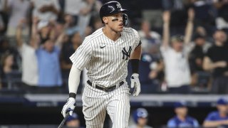 Jul 29, 2022; Bronx, New York, USA; New York Yankees right fielder Aaron Judge (99) hits a grand slam home run in the eighth inning against the Kansas City Royals at Yankee Stadium. Mandatory Credit: Wendell Cruz-USA TODAY Sports