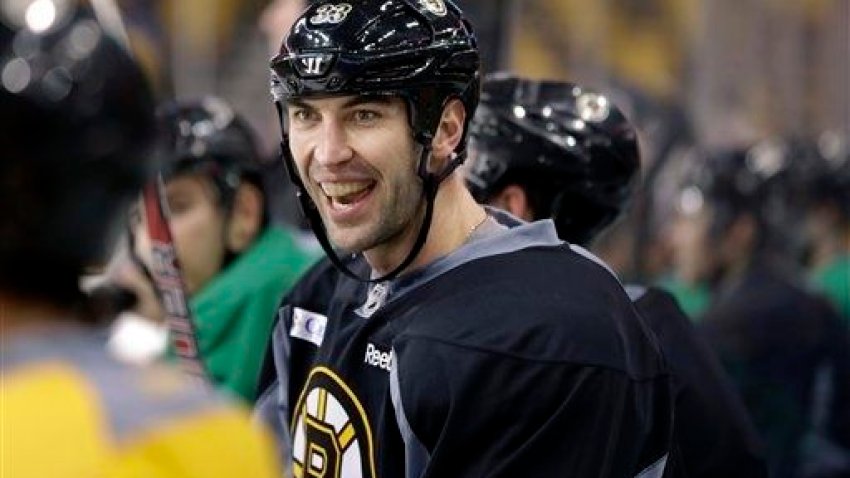 Boston Bruins’ Zdeno Chara, of Slovakia, smiles while speaking with teammates on the bench during an NHL hockey team practice at the TD Garden, in Boston, Sunday, Jan. 13, 2013. (AP Photo/Steven Senne)