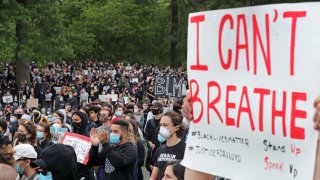 BOSTON, MA – JUNE 2: Activists participate in a rally, vigil and march hosted by Black Lives Matter (BLM) and Violence in Boston on June 2, 2020. The rally and vigil took place on Blue Hill Avenue by Franklin Park to honor George Floyd, Breanna Taylor, Ahmaud Arbery and local fallen people, and to protest police brutality. (Photo by Jim Davis/The Boston Globe via Getty Images)