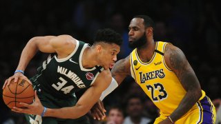 March 6, 2020; Los Angeles, California, USA; Milwaukee Bucks forward Giannis Antetokounmpo (34) controls the ball against Los Angeles Lakers forward LeBron James (23) during the first half at Staples Center. Mandatory Credit: Gary A. Vasquez-USA TODAY Sports