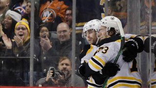 Boston Bruins’ Jake DeBrusk, left, celebrates with teammate Charlie McAvoy (73) after scoring a goal during the second period of an NHL hockey game against the New York Islanders, Saturday, Jan. 11, 2020, in New York. (AP Photo/Frank Franklin II)