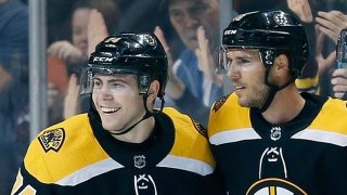 Boston Bruins’ David Krejci, center, of the Czech Republic, celebrates his goal with Jake DeBrusk (74) and Charlie McAvoy (73) during the first period of an NHL hockey game against the Vancouver Canucks in Boston, Thursday, Oct. 19, 2017. (AP Photo/Michael Dwyer)