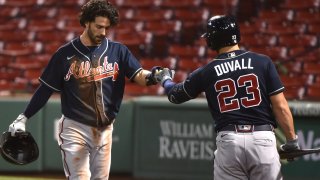 Aug 31, 2020; Boston, Massachusetts, USA; Atlanta Braves shortstop Dansby Swanson (7) is congratulated by right fielder Adam Duvall (23) after scoring a run during the first inning against the Boston Red Sox at Fenway Park. Mandatory Credit: Bob DeChiara-USA TODAY Sports