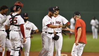 Aug 10, 2020; Boston, Massachusetts, USA; Boston Red Sox relief pitcher Marcus Walden (64) hands the ball to manager Ron Roenicke after being relieved during the fifth inning against the Tampa Bay Rays at Fenway Park. Mandatory Credit: Bob DeChiara-USA TODAY Sports