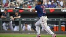 Rafael Devers hits a single against the Twins.