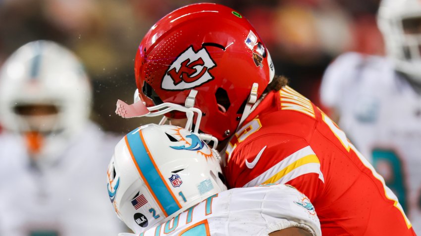 Kansas City Chiefs quarterback Patrick Mahomes (15) helmet cracks taking a hit from Miami Dolphins safety DeShon Elliott (21) in the third quarter of an AFC Wild Card playoff game between the Miami Dolphins and Kansas City Chiefs on Jan 13, 2024 at GEHA Field at Arrowhead Stadium in Kansas City, MO.