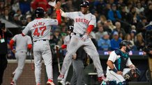 SEATTLE, WASHINGTON - MARCH 28: Rafael Devers #11 of the Boston Red Sox celebrates with Enmanuel Valdez #47 after hitting a two-run home run during the third inning of the Opening Day game against the Seattle Mariners at T-Mobile Park on March 28, 2024 in Seattle, Washington. (Photo by Alika Jenner/Getty Images)