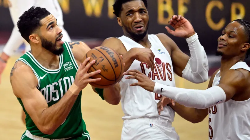 May 11, 2024; Cleveland, Ohio, USA; Boston Celtics forward Jayson Tatum (0) drives against Cleveland Cavaliers guard Donovan Mitchell (45) and forward Isaac Okoro (35) in the first quarter of game three of the second round of the 2024 NBA playoffs at Rocket Mortgage FieldHouse. Mandatory Credit: David Richard-USA TODAY Sports