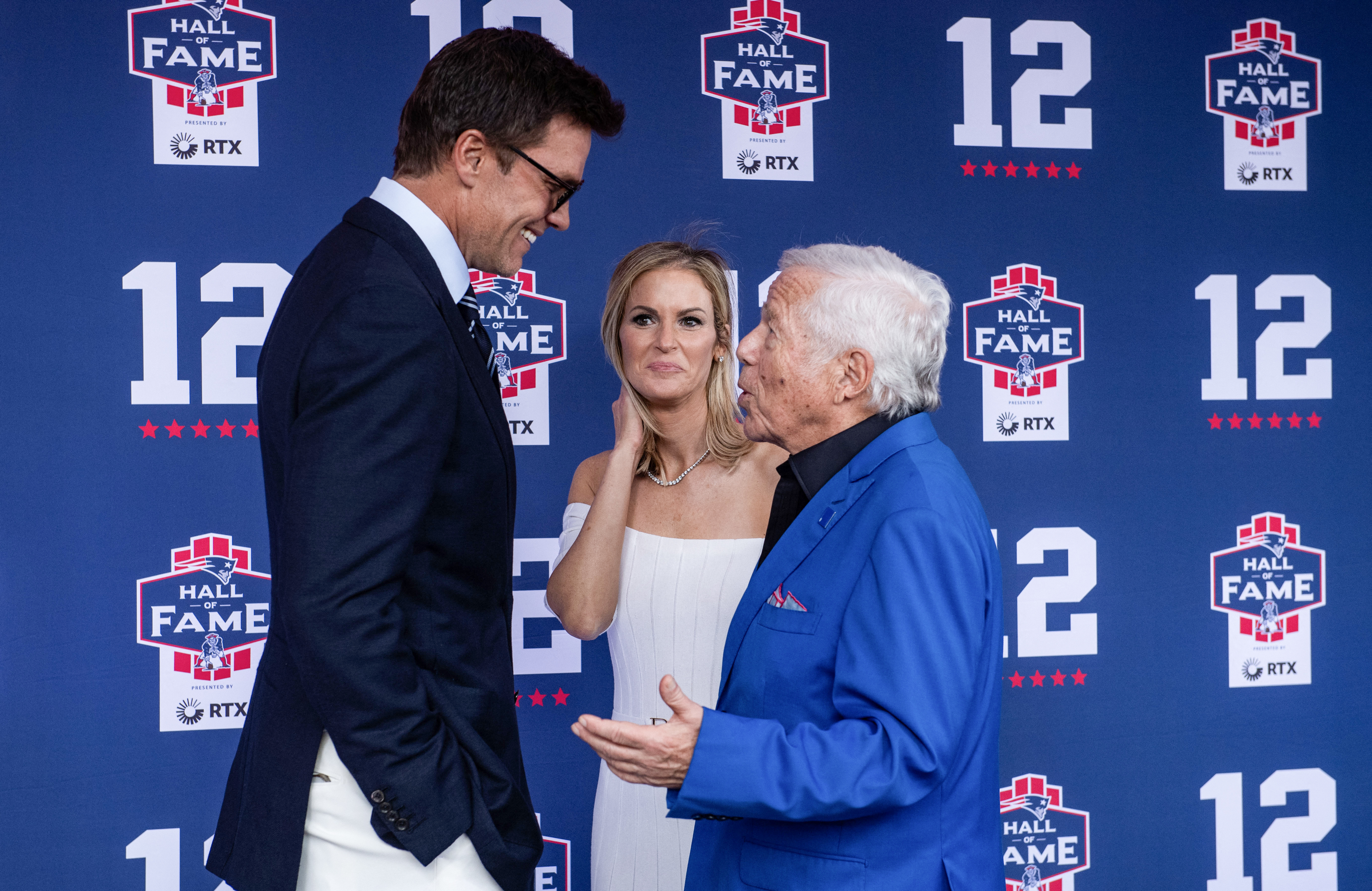 Former New England Patriots quarterback Tom Brady talks with CEO of the New England Patriots Robert Kraft (R) and his wife  Dana Blumberg as they arrive for Brady’s 2024 Hall of Fame induction ceremony at Gillette Stadium in Foxborough, Massachusetts, on June 12, 2024. Tom Brady is the 35th person to be inducted into the Patriots Hall of Fame.