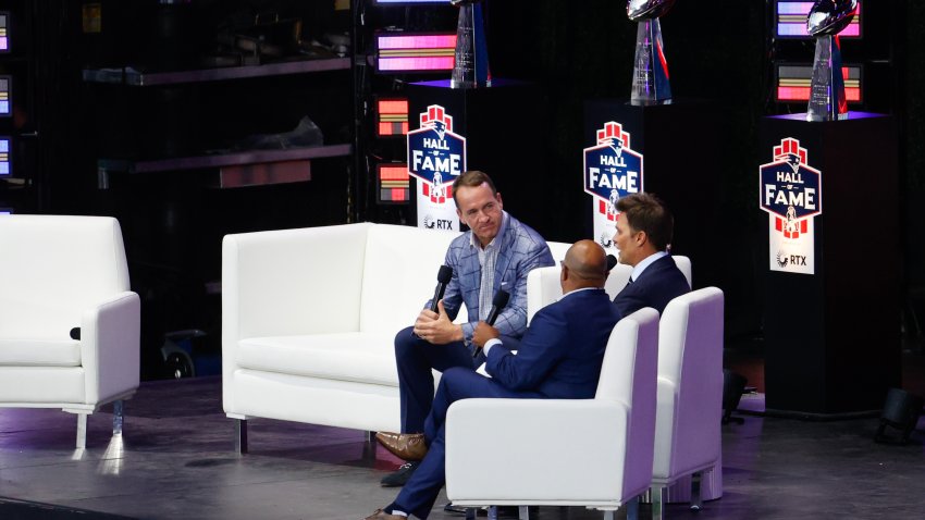 Peyton Manning, Tom Brady and Mike Tirico talk during the 2024 Hall of Fame Induction Ceremony for Tom Brady at Gillette Stadium on June 12, 2024 in Foxborough, Massachusetts.