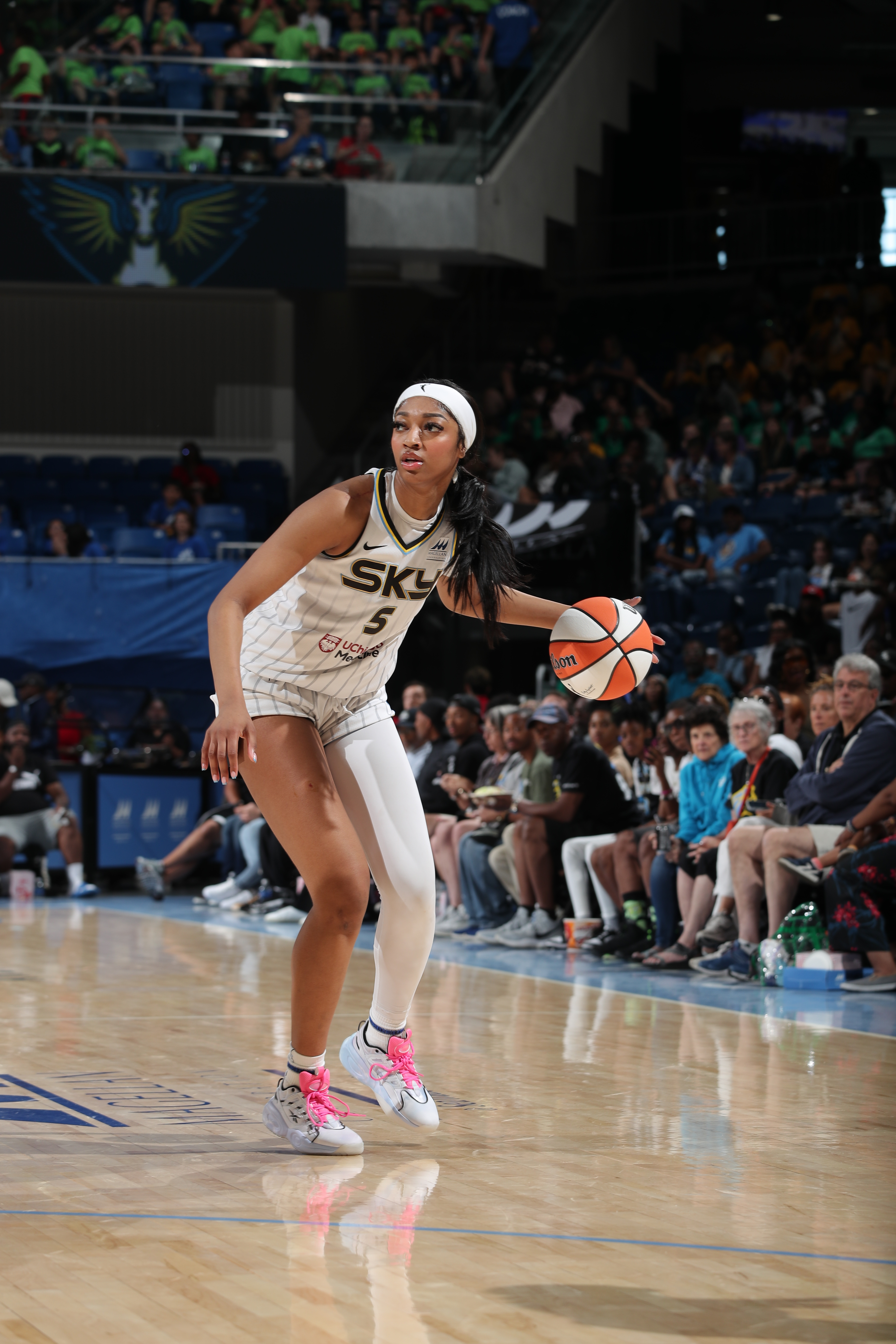 CHICAGO, IL –  JUNE 20: Angel Reese #5 of the Chicago Sky dribbles the ball during the game against the Dallas Wings on June 20, 2024 at the Wintrust Arena in Chicago, IL. NOTE TO USER: User expressly acknowledges and agrees that, by downloading and or using this photograph, User is consenting to the terms and conditions of the Getty Images License Agreement. Mandatory Copyright Notice: Copyright 2024 NBAE (Photo by Gary Dineen/NBAE via Getty Images)