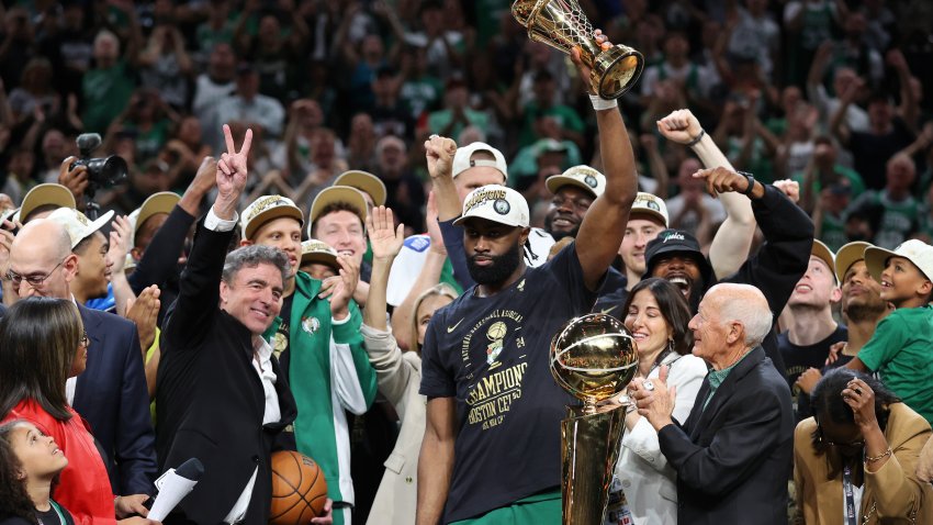 Jun 17, 2024; Boston, Massachusetts, USA; Boston Celtics guard Jaylen Brown (7) holds the MVP trophy after winning the 2024 NBA Finals against the Dallas Mavericks at TD Garden. Mandatory Credit: Peter Casey-USA TODAY Sports