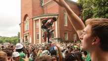 A Boston Celtics fan atop a parking meter in the city before the team's championship's parade on Friday, June 21, 2024.