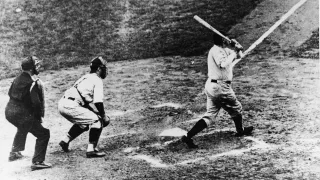 American baseball player Babe Ruth of the New York Yankees hits a home run in Game 3 of the World Series