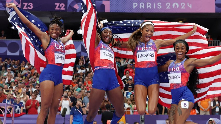 The U.S. women's track team celebrating after winning gold.