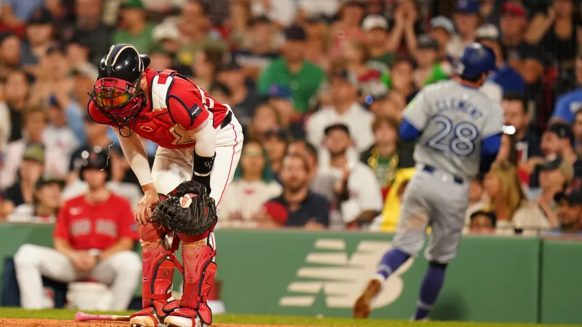 Aug 26, 2024; Boston, Massachusetts, USA; Boston Red Sox catcher Connor Wong (12) reacts after Toronto Blue Jays third baseman Ernie Clement (28) scores in the ninth inning at Fenway Park. Mandatory Credit: David Butler II-USA TODAY Sports