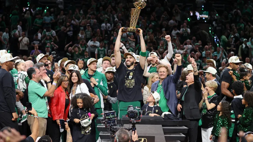 Jun 17, 2024; Boston, Massachusetts, USA; Boston Celtics forward Jayson Tatum (0) lifts the trophy after winning the 2024 NBA Finals against the Dallas Mavericks at TD Garden. Mandatory Credit: Peter Casey-USA TODAY Sports