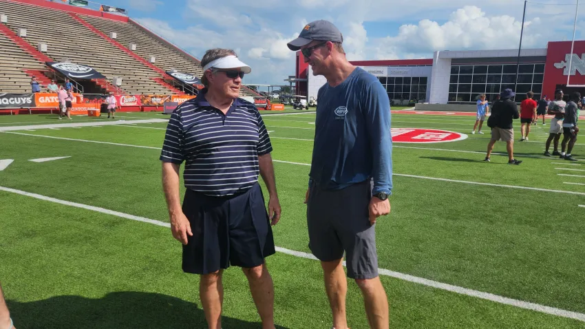 Legendary former NFL coach Bill Belichick talks with Peyton Manning at the 2024 Manning Passing Academy.