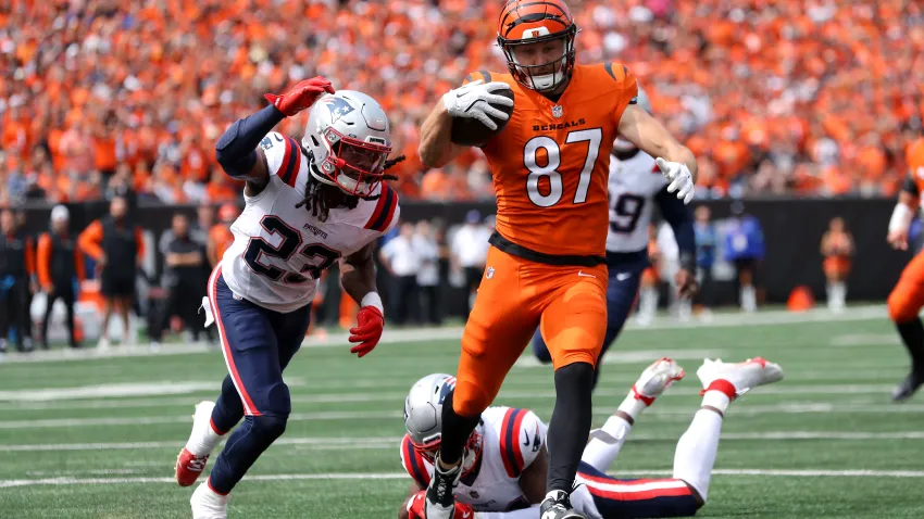 Sep 8, 2024; Cincinnati, Ohio, USA;  Cincinnati Bengals tight end Tanner Hudson (87) runs to the end zone, but eventually fumbles the ball as New England Patriots safety Kyle Dugger (23) causes the turnover during the second quarter at Paycor Stadium. Mandatory Credit: Joseph Maiorana-Imagn Images