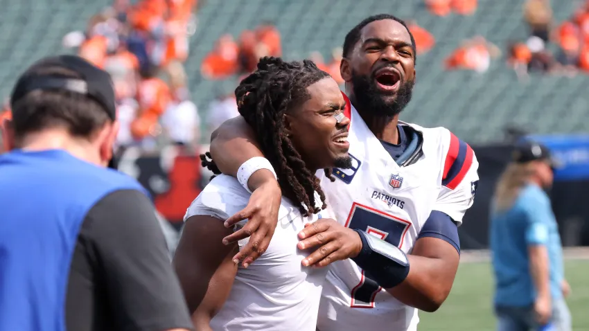 Sep 8, 2024; Cincinnati, Ohio, USA;  New England Patriots quarterback Jacoby Brissett (right) celebrates following the win over the Cincinnati Bengals at Paycor Stadium. Mandatory Credit: Joseph Maiorana-Imagn Images