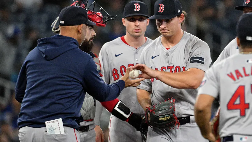 Sep 24, 2024; Toronto, Ontario, CAN;  Boston Red Sox manager Alex Cora (13) relieves pitcher Zach Penrod (67)  against the Toronto Blue Jays in the 10th inning at Rogers Centre. Mandatory Credit: Dan Hamilton-Imagn Images