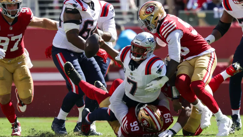 Sep 29, 2024; Santa Clara, California, USA; New England Patriots quarterback Jacoby Brissett (7) is sacked by San Francisco 49ers defensive tackle Maliek Collins (99) during the second quarter at Levi’s Stadium. Mandatory Credit: Sergio Estrada-Imagn Images