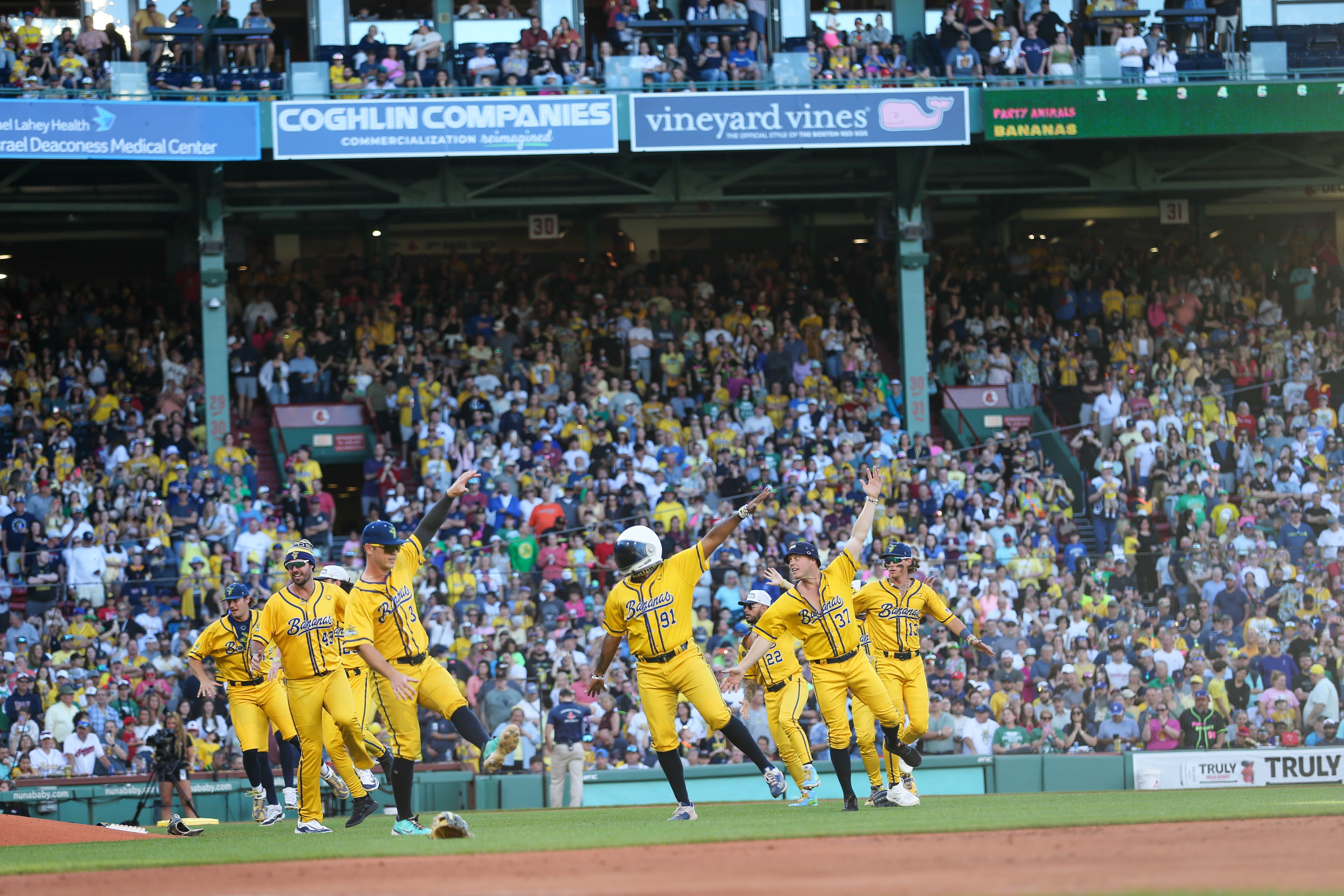 Savannah Bananas players dance on the field before the start of their first Banana Ball game at Fenway Park in Boston on Saturday, June 8, 2024.