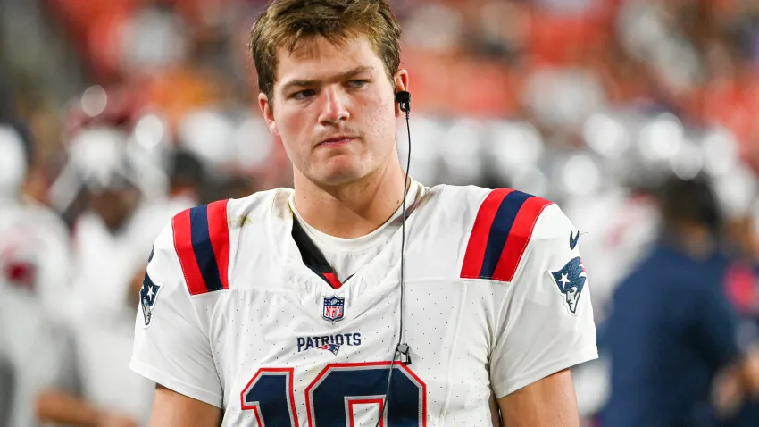 Aug 25, 2024; Landover, Maryland, USA;  New England Patriots quarterback Drake Maye (10) stands in the bench area during the second  half against the Washington Commanders at Commanders Field. Mandatory Credit: Tommy Gilligan-USA TODAY Sports