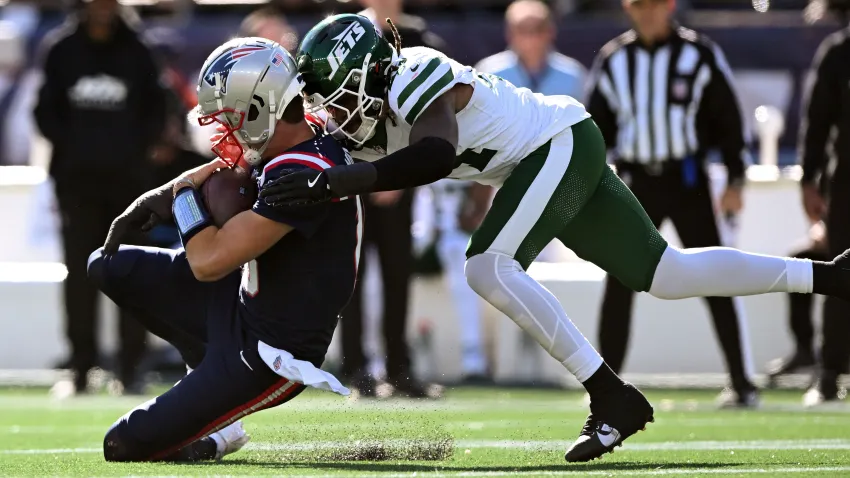 Oct 27, 2024; Foxborough, Massachusetts, USA; New England Patriots quarterback Drake Maye (10) is tackled by New York Jets linebacker Jamien Sherwood (44) during the first half at Gillette Stadium. Mandatory Credit: Brian Fluharty-Imagn Images