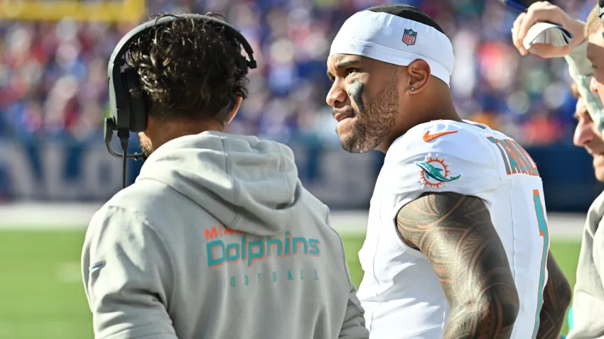 Nov 3, 2024; Orchard Park, New York, USA; Miami Dolphins quarterback Tua Tagovailoa (1) on the sidelines with head coach Mike McDaniel in the second quarter game against the Buffalo Bills at Highmark Stadium. Mandatory Credit: Mark Konezny-Imagn Images