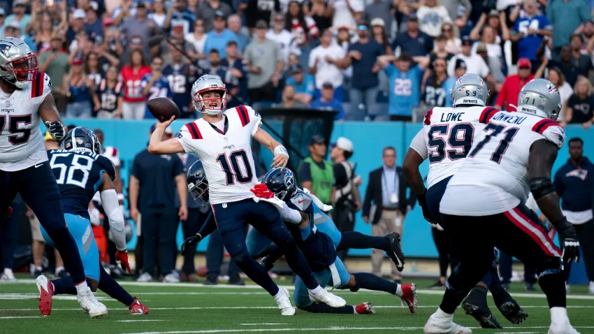 New England Patriots quarterback Drake Maye (10) throws while in the grasp of Tennessee Titans safety Mike Brown (44) during their game at Nissan Stadium in Nashville, Tenn., Sunday, Nov. 3, 2024. It was the last play of regulation and the New England Patriots running back Rhamondre Stevenson (38) came up with the reception in the end zone to force overtime. The play lasted more than 11 seconds as Mayes kept the play alive under constant pressure.