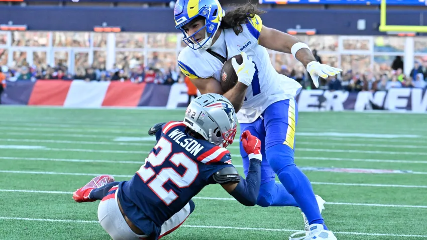 Nov 17, 2024; Foxborough, Massachusetts, USA;  New England Patriots cornerback Marco Wilson (22) tries to tackle Los Angeles Rams wide receiver Puka Nacua (17) during the first half at Gillette Stadium. Mandatory Credit: Eric Canha-Imagn Images