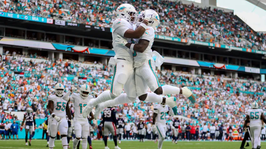 Nov 24, 2024; Miami Gardens, Florida, USA; Miami Dolphins tight end Jonnu Smith (9) celebrates with wide receiver Tyreek Hill (10) after scoring a touchdown against the New England Patriots during the first quarter at Hard Rock Stadium. Mandatory Credit: Sam Navarro-Imagn Images