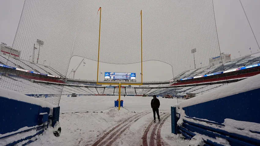 Tire mark trails lead in and off the field as trucks come and go carrying snow out of the stadium after they were filled. The Bills were working on keeping the field in game shape before tonightÕs Bills home game against the San Francisco 49ers in Orchard Park on Dec. 1, 2024.