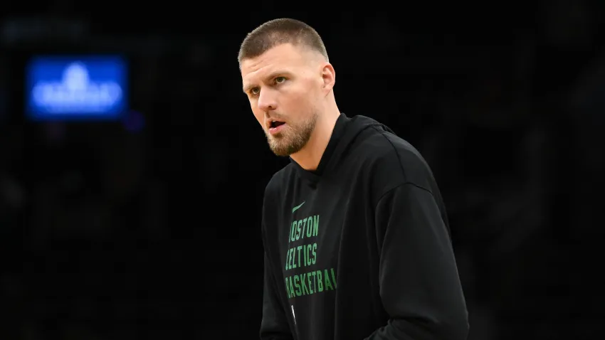 Dec 4, 2024; Boston, Massachusetts, USA; Boston Celtics center Kristaps Porzingis (8) holds his wrist during warmups before a game against the Detroit Pistons at the TD Garden. Mandatory Credit: Brian Fluharty-Imagn Images