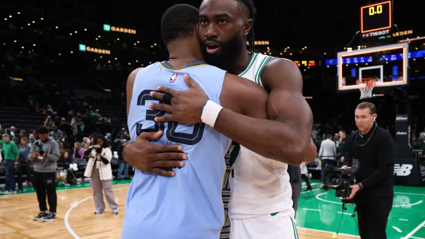 Dec 7, 2024; Boston, Massachusetts, USA; Boston Celtics forward Jaylen Brown (7) and Memphis Grizzlies guard Marcus Smart (36) hug after the Memphis Grizzlies defeat the Boston Celtics at TD Garden. Mandatory Credit: Paul Rutherford-Imagn Images