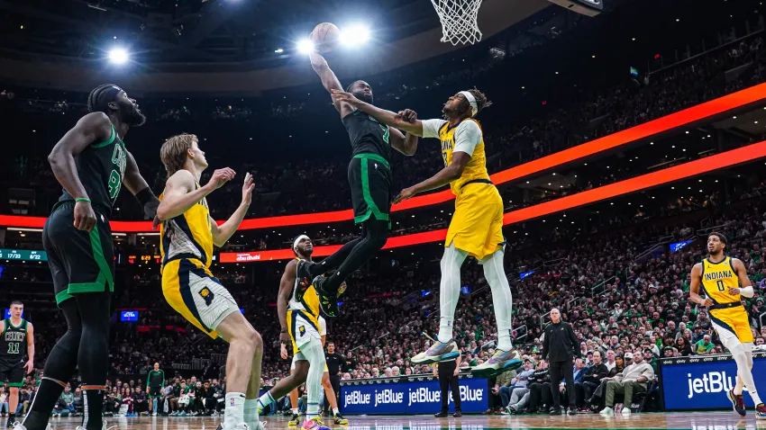 Dec 27, 2024; Boston, Massachusetts, USA; Boston Celtics guard Jaylen Brown (7) makes the basket against Indiana Pacers center Myles Turner (33) in the second quarter at TD Garden. Mandatory Credit: David Butler II-Imagn Images