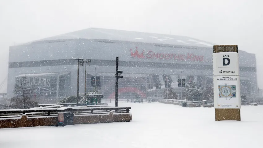 Snow falls on the Smoothie King Center in New Orleans