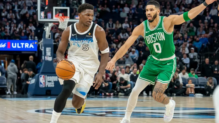 Jan 2, 2025; Minneapolis, Minnesota, USA; Minnesota Timberwolves guard Anthony Edwards (5) dribbles past Boston Celtics forward Jayson Tatum (0) in the second half at Target Center. Mandatory Credit: Jesse Johnson-Imagn Images