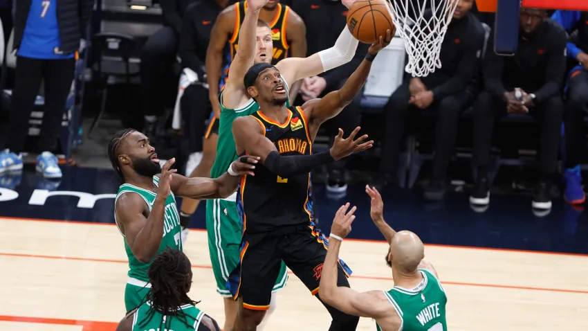 Jan 5, 2025; Oklahoma City, Oklahoma, USA; Oklahoma City Thunder guard Shai Gilgeous-Alexander (2) shoots the ball defended by Boston Celtics guard Jaylen Brown (7) during the first quarter at Paycom Center. Mandatory Credit: Alonzo Adams-Imagn Images