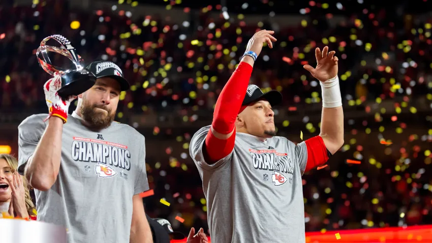 Jan 26, 2025; Kansas City, MO, USA; Confetti falls as Kansas City Chiefs tight end Travis Kelce (left) celebrates with the Lamar Hunt Trophy with quarterback Patrick Mahomes after defeating the Buffalo Bills during the AFC Championship game at GEHA Field at Arrowhead Stadium. Mandatory Credit: Mark J. Rebilas-Imagn Images