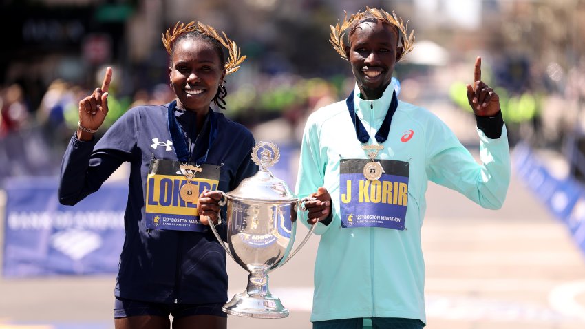 BOSTON, MASSACHUSETTS – APRIL 21: (L-R) Sharon Lokedi of Kenya and John Korir of Kenya celebrate with their trophies after winning the 129th Boston Marathon on April 21, 2025 in Boston, Massachusetts. (Photo by Maddie Meyer/Getty Images)