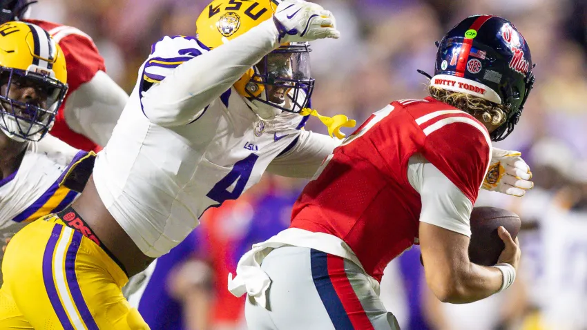 Oct 12, 2024; Baton Rouge, Louisiana, USA;  LSU Tigers defensive end Bradyn Swinson (4) sacks Mississippi Rebels quarterback Jaxson Dart (2) during the second half at Tiger Stadium. Mandatory Credit: Stephen Lew-Imagn Images