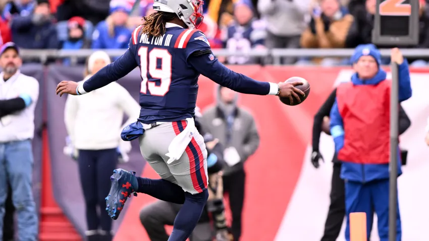 Jan 5, 2025; Foxborough, Massachusetts, USA; New England Patriots quarterback Joe Milton III (19) runs for a touchdown against the Buffalo Bills during the first half at Gillette Stadium. Mandatory Credit: Brian Fluharty-Imagn Images