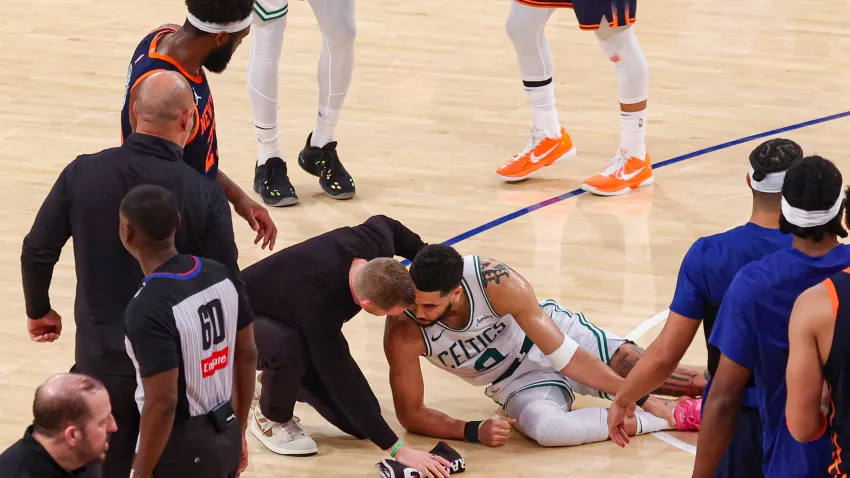 May 12, 2025; New York, New York, USA; Boston Celtics forward Jayson Tatum (0) with a member of the medical staff on the court after an injury in the second half during game four of the second round for the 2025 NBA Playoffs against the New York Knicks at Madison Square Garden. Tatum would leave the game with an injury after this play. Mandatory Credit: Vincent Carchietta-Imagn Images