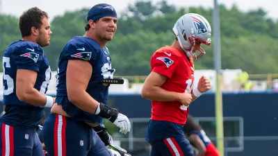 Patriots quarterback Drake Maye with offensive tackle Will Campbell and tight end Hunter Henry